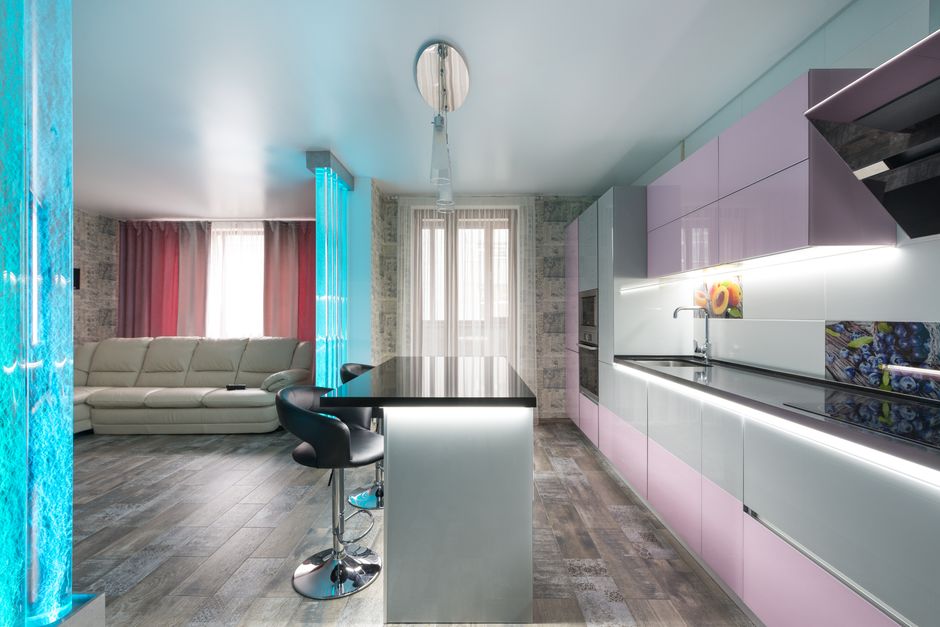 Interior of modern flat with kitchen equipped with modern appliances separated from living room with bubble wall