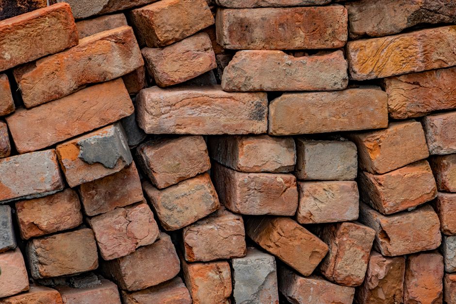 Close-up of uneven stacked bricks showing texture and color variations.
