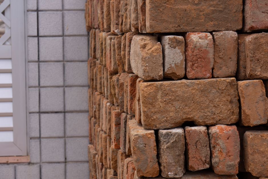 Detailed view of a red brick wall showcasing the texture and construction materials used in architectural projects.