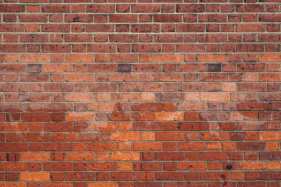 Detailed image of a red brick wall, ideal for use as a background texture.