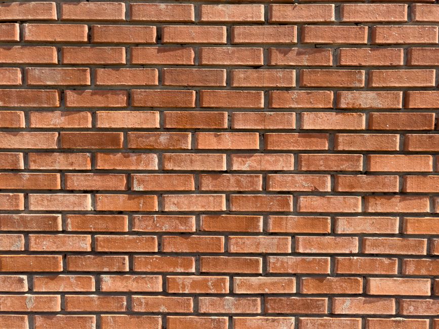 High-resolution image of a red brick wall texture with detailed rustic patterns.
